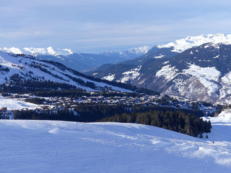 Courchevel and its pistes seen from the slopes, with the Vanoise peaks behind