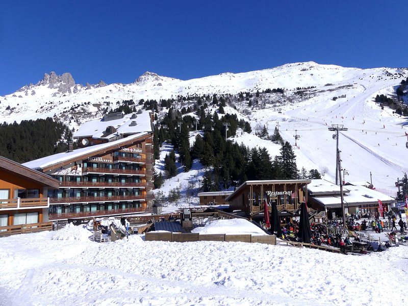 Meribel village at the foot of its pistes, with the Aiguille du Fruit behind